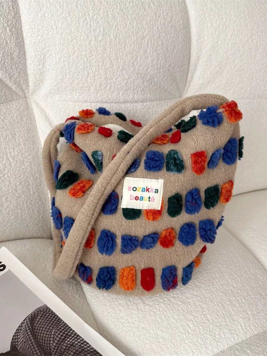 Colorful textured bag with a visible brand label on a light background