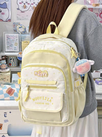 Light yellow backpack with 'Nudy' branding worn by a person in a room with decorative items.