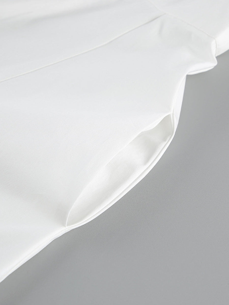 Close-up of a white satin pillowcase on a gray background