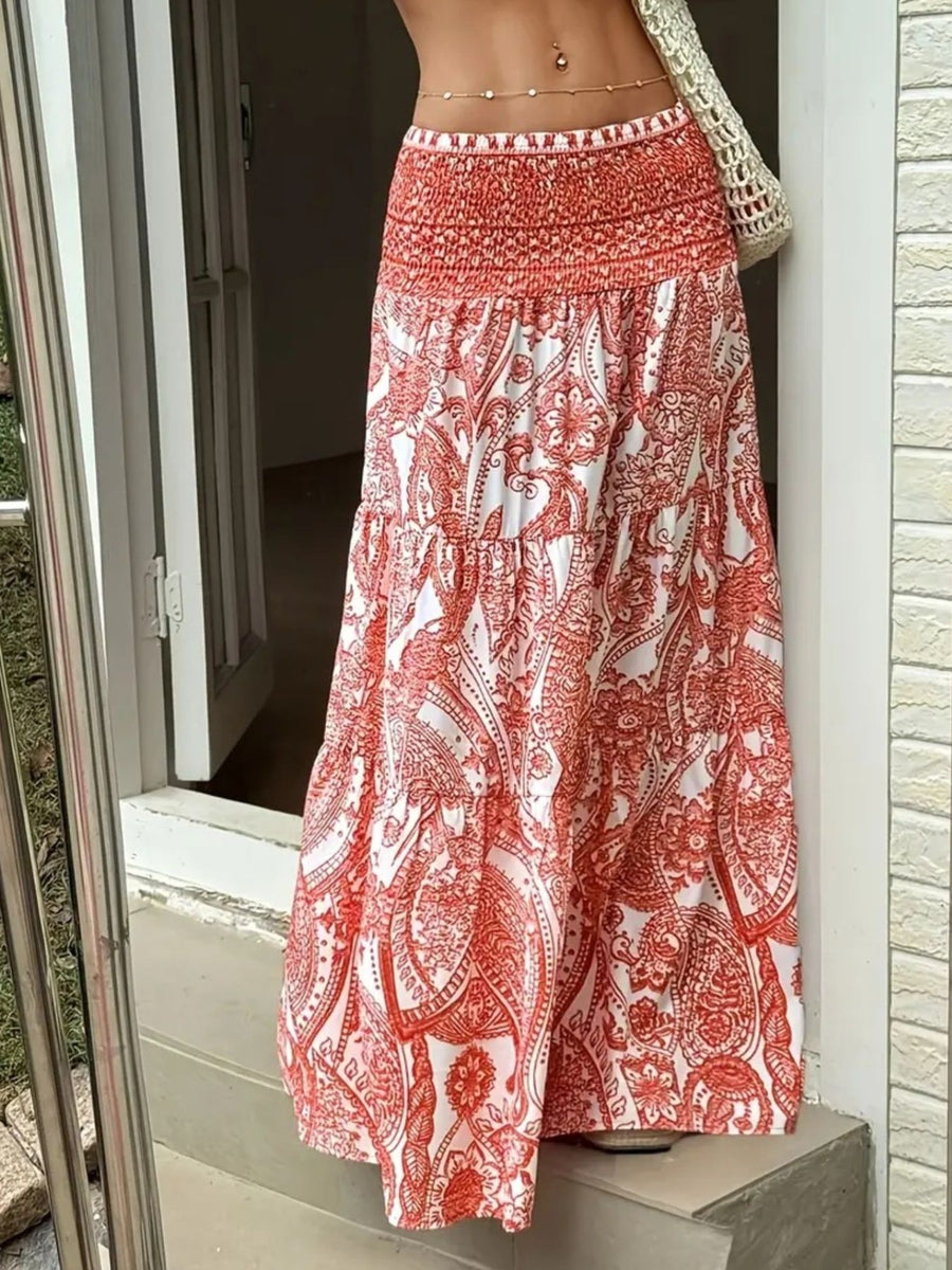 Red and white patterned skirt being worn by a person standing outside.