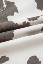 Close-up of fabric with black floral pattern on white background
