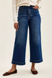 Person wearing blue jeans on a white background