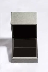 Silver jewelry box with a textured lid on a white background