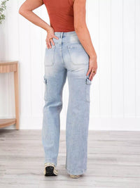 Person wearing light blue jeans and a rust-colored top indoors.