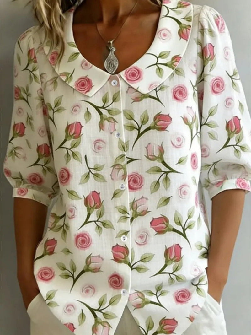 Floral patterned blouse with pink roses on a white background