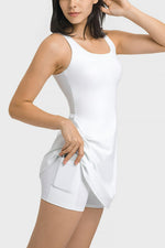Woman wearing a white sleeveless top and shorts on a light gray background