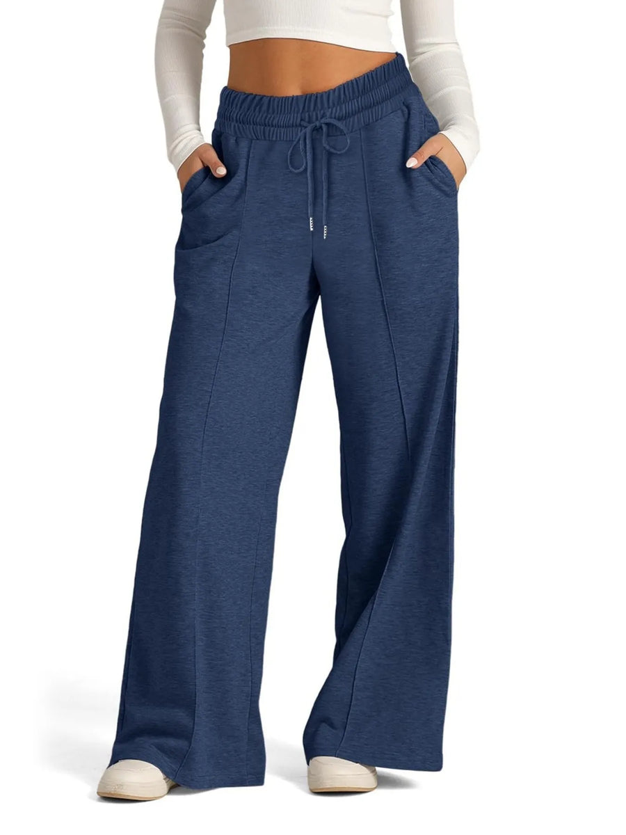Blue wide-leg pants worn by a person on a white background