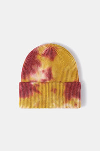 Tie-dye beanie with yellow and red pattern on a white background
