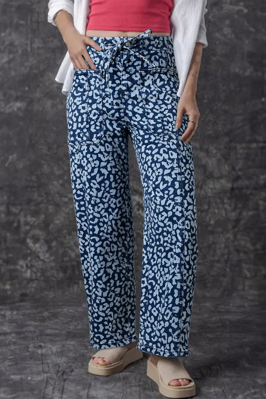 Person wearing blue patterned pants with a plain background