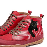 Red high-top sneakers with a black cat design on a white background