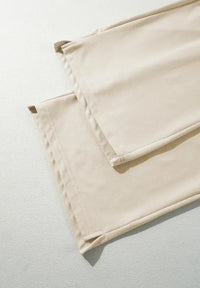 Folded beige fabric on a light gray background