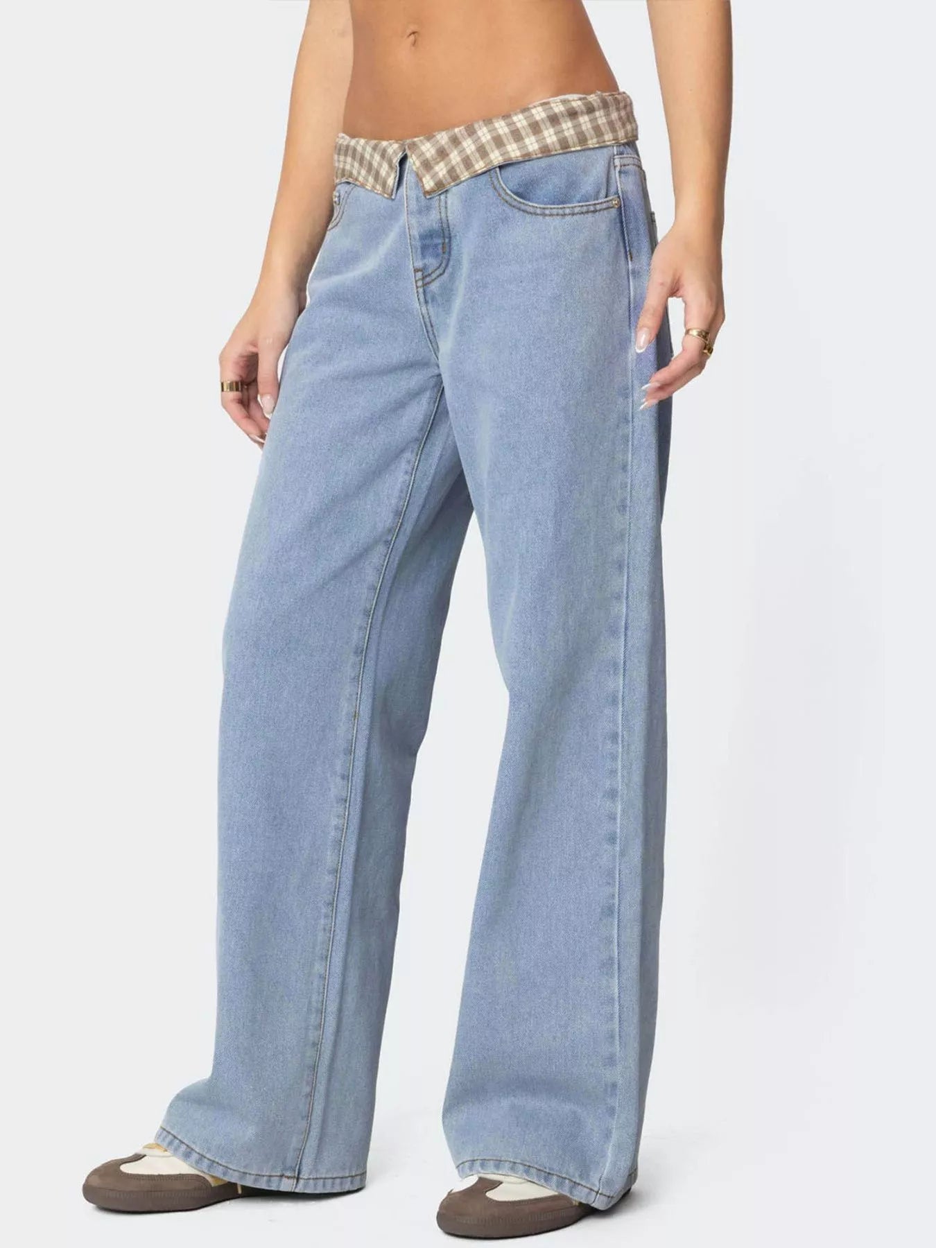 Light blue jeans with a plaid waistband on a white background