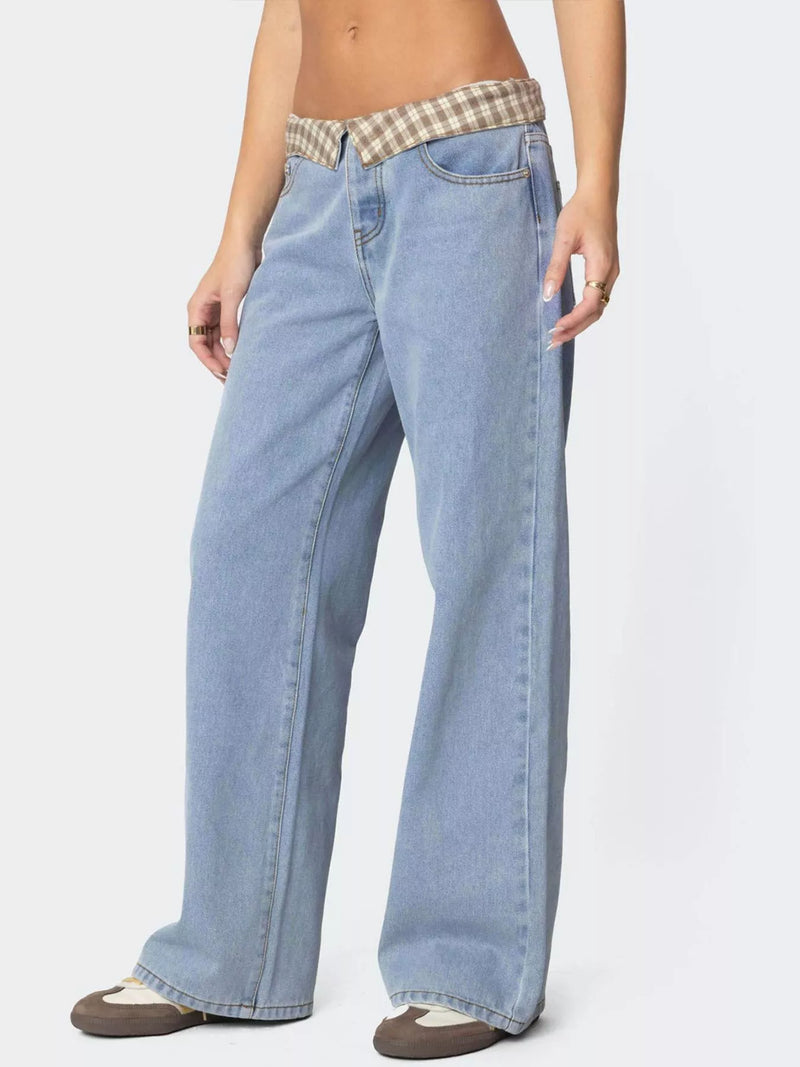 Light blue jeans with a plaid waistband on a white background