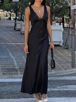 Woman in a black dress standing on a city street