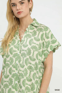 Woman wearing a green and white patterned shirt on a white background