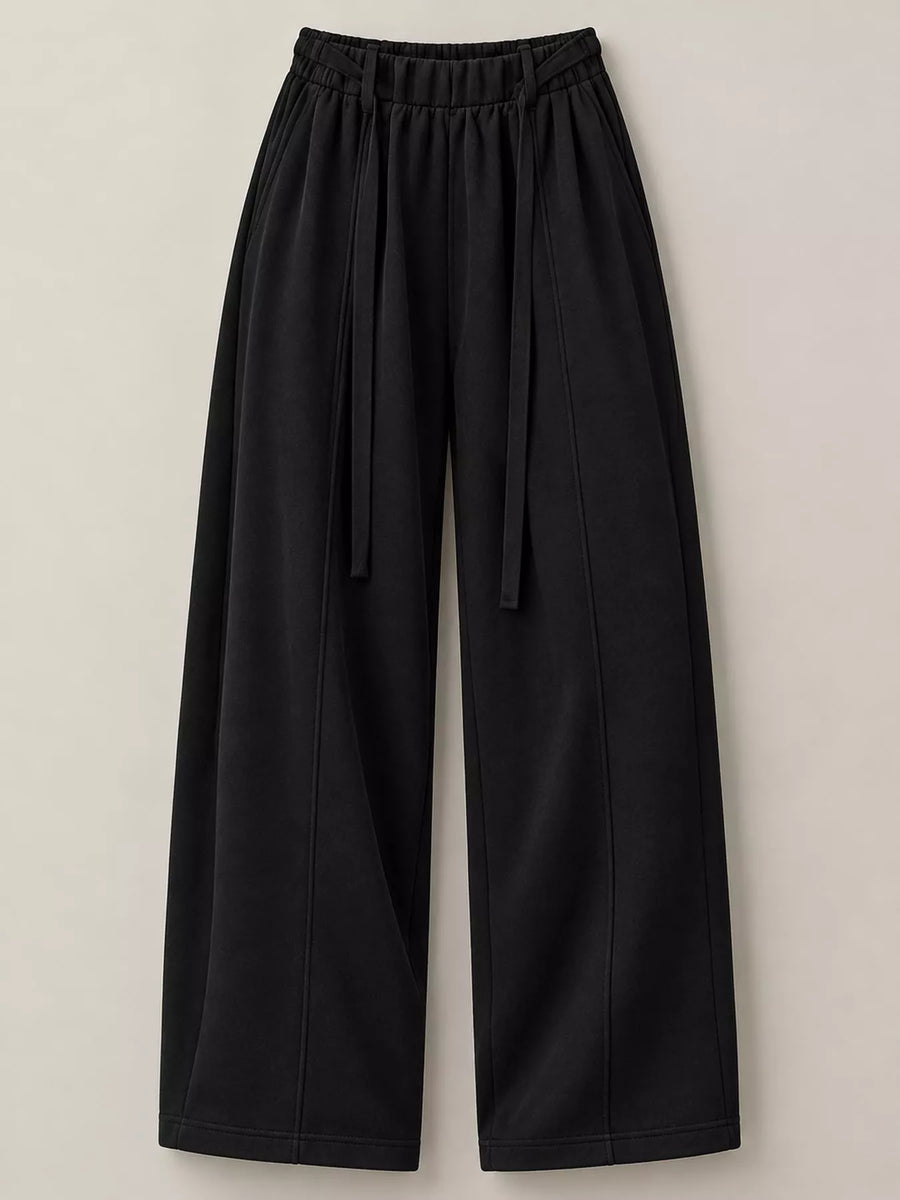 Black wide-leg cropped pants with an elastic drawstring waist, shown flat against a light beige background.