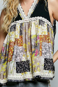 Multicolored patchwork top with lace details on a plain background