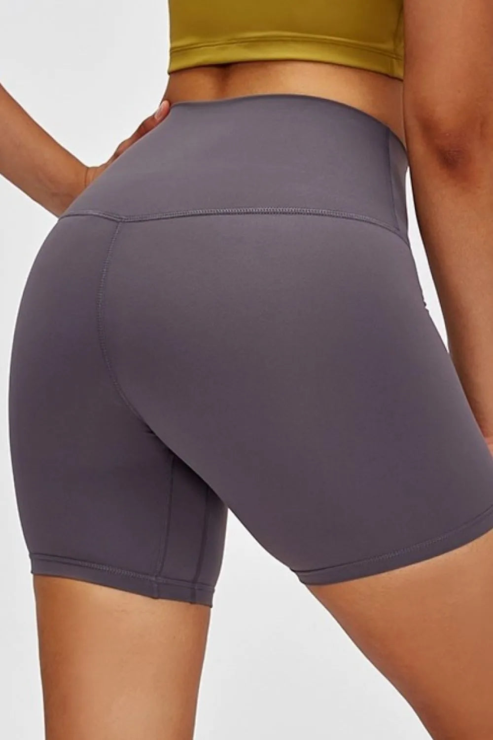 Person wearing gray athletic shorts on a plain background