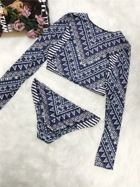 Blue and white patterned long-sleeve top on a white background