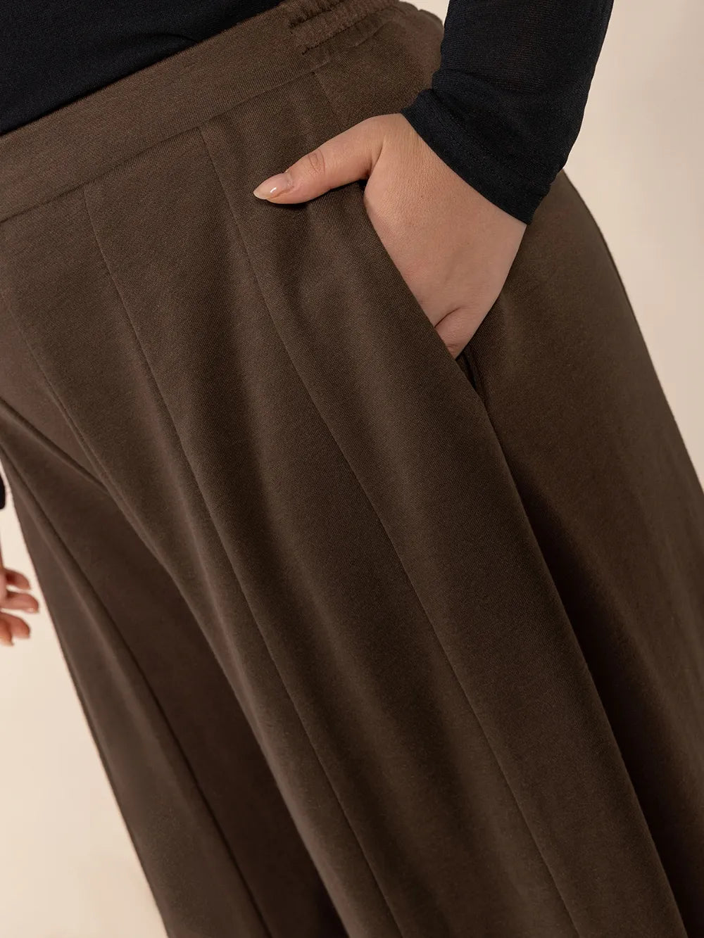 Brown wide-leg pants with a neutral background