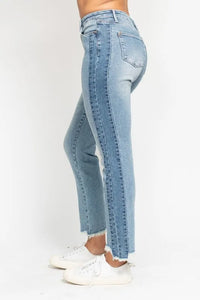 Light blue jeans worn by a person on a white background