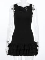 Black dress with ruffled hem on a transparent mannequin against a white background