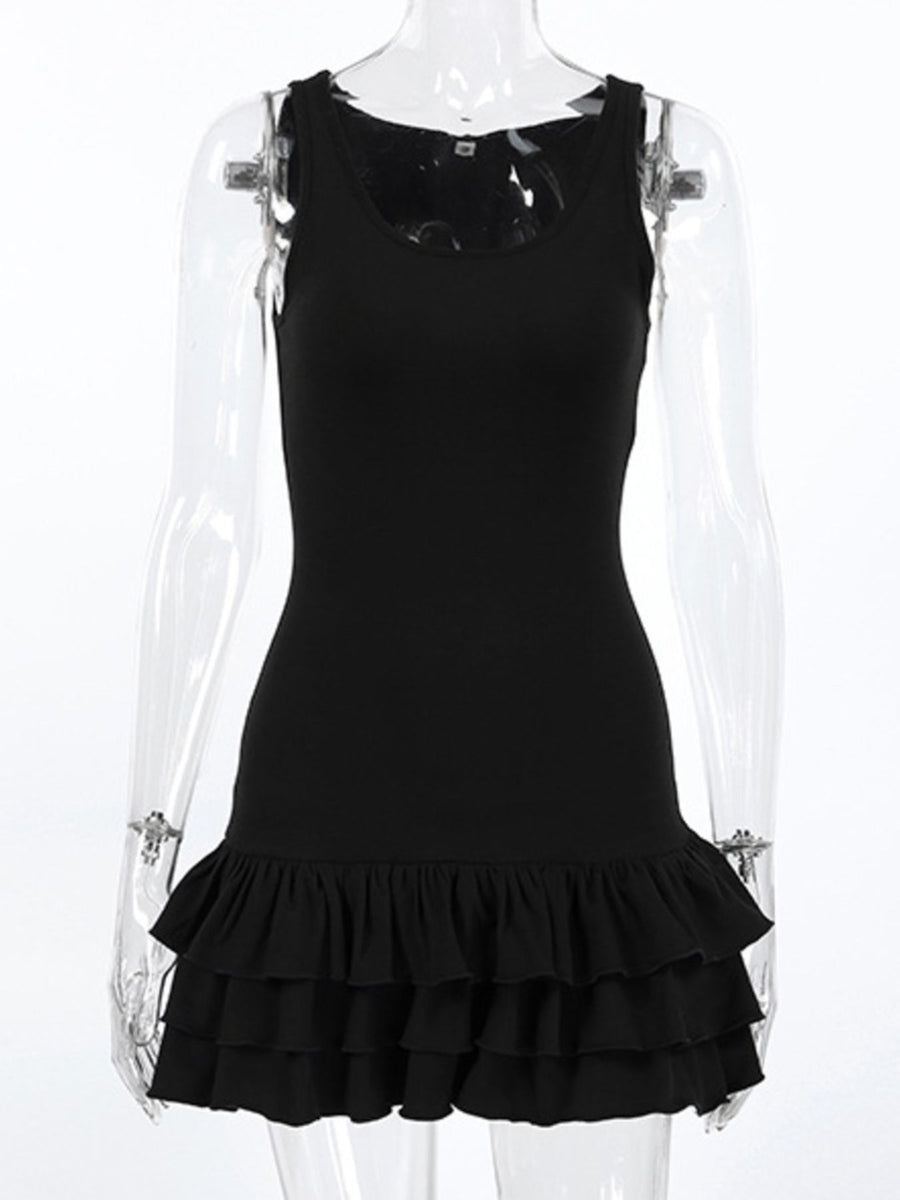 Black dress with ruffled hem on a transparent mannequin against a white background