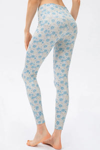 Light blue floral-patterned leggings worn by a person on a white background