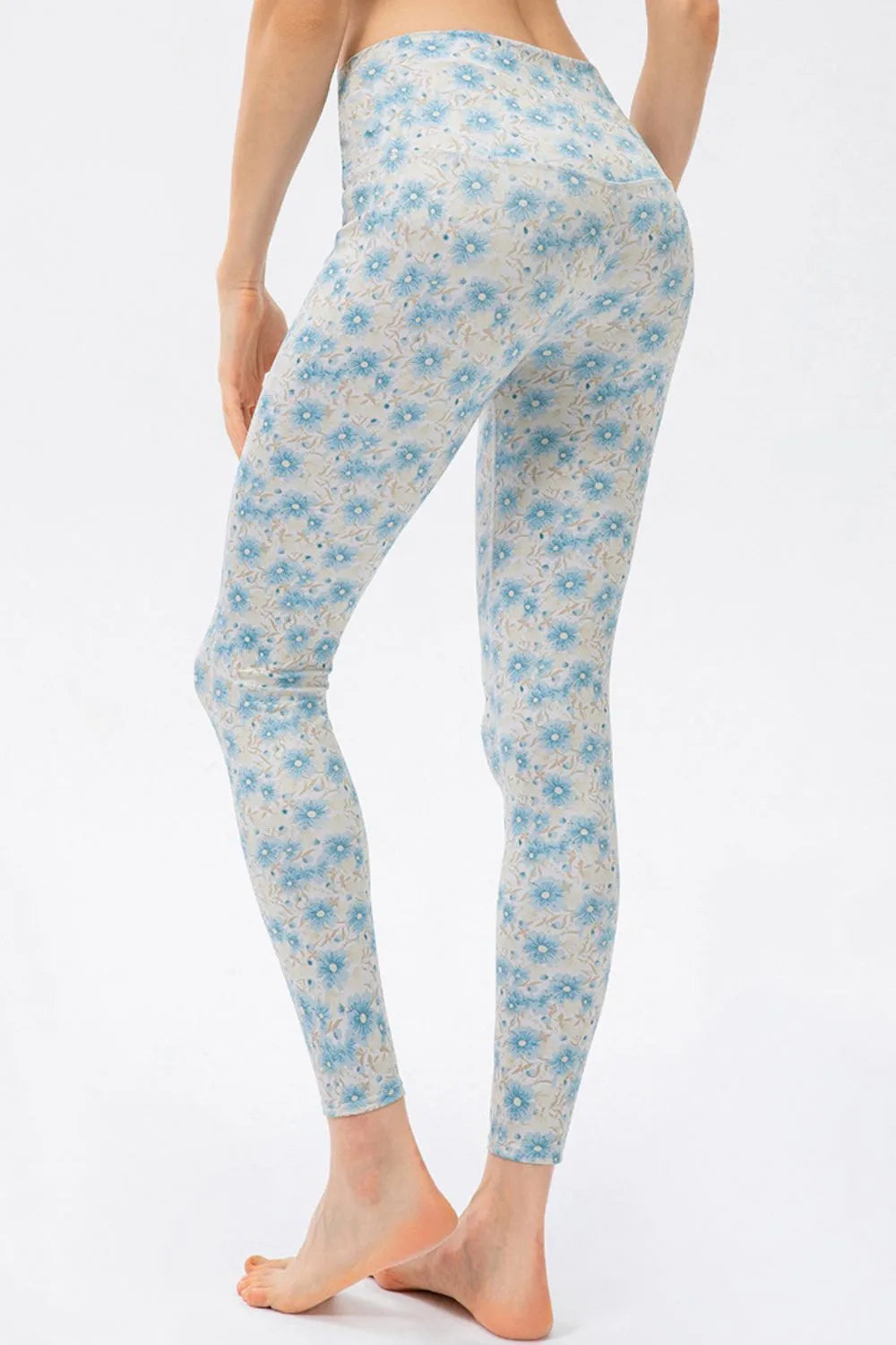 Light blue floral-patterned leggings worn by a person on a white background