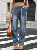 Person wearing blue cargo pants on a city street