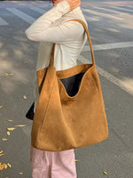 A woman wearing a Vintage Hobo Shoulder Bag