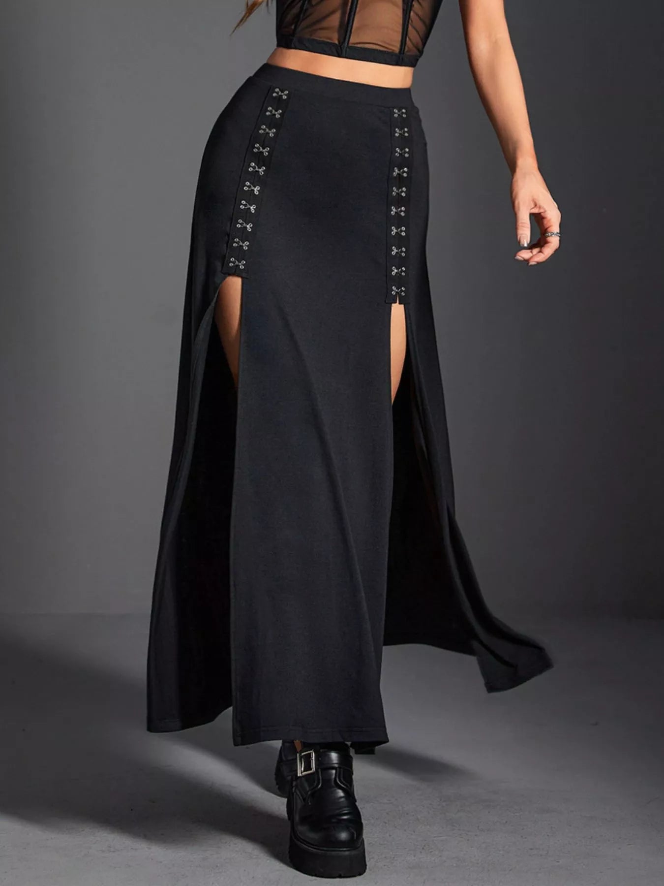 Black long skirt with front slit and lace-up details on a gray background