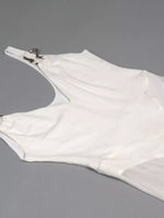 White glove with a metallic clasp on a gray background