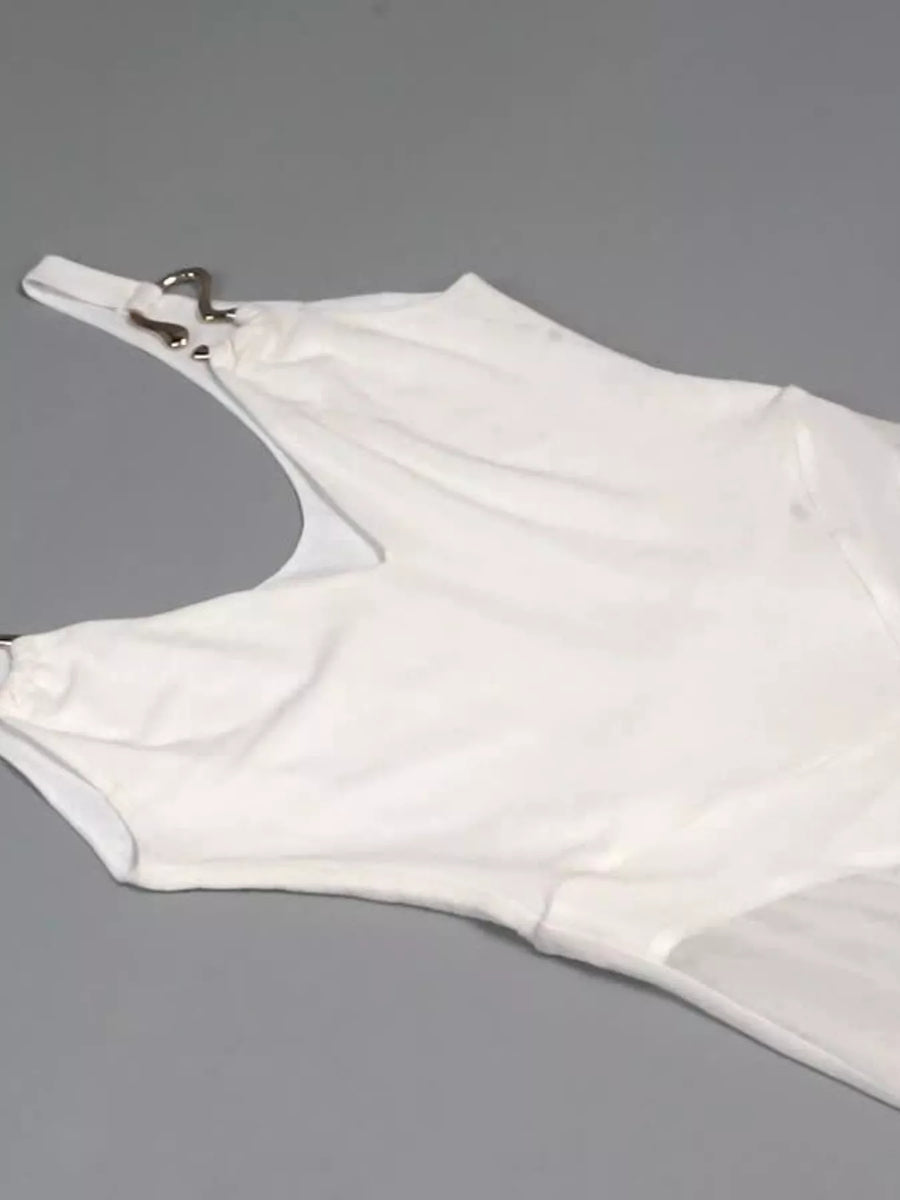 White glove with a metallic clasp on a gray background