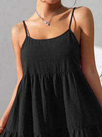 Black dress worn by a person against a neutral background
