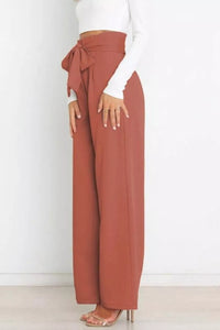 Brown wide-leg pants with a white top on a white background