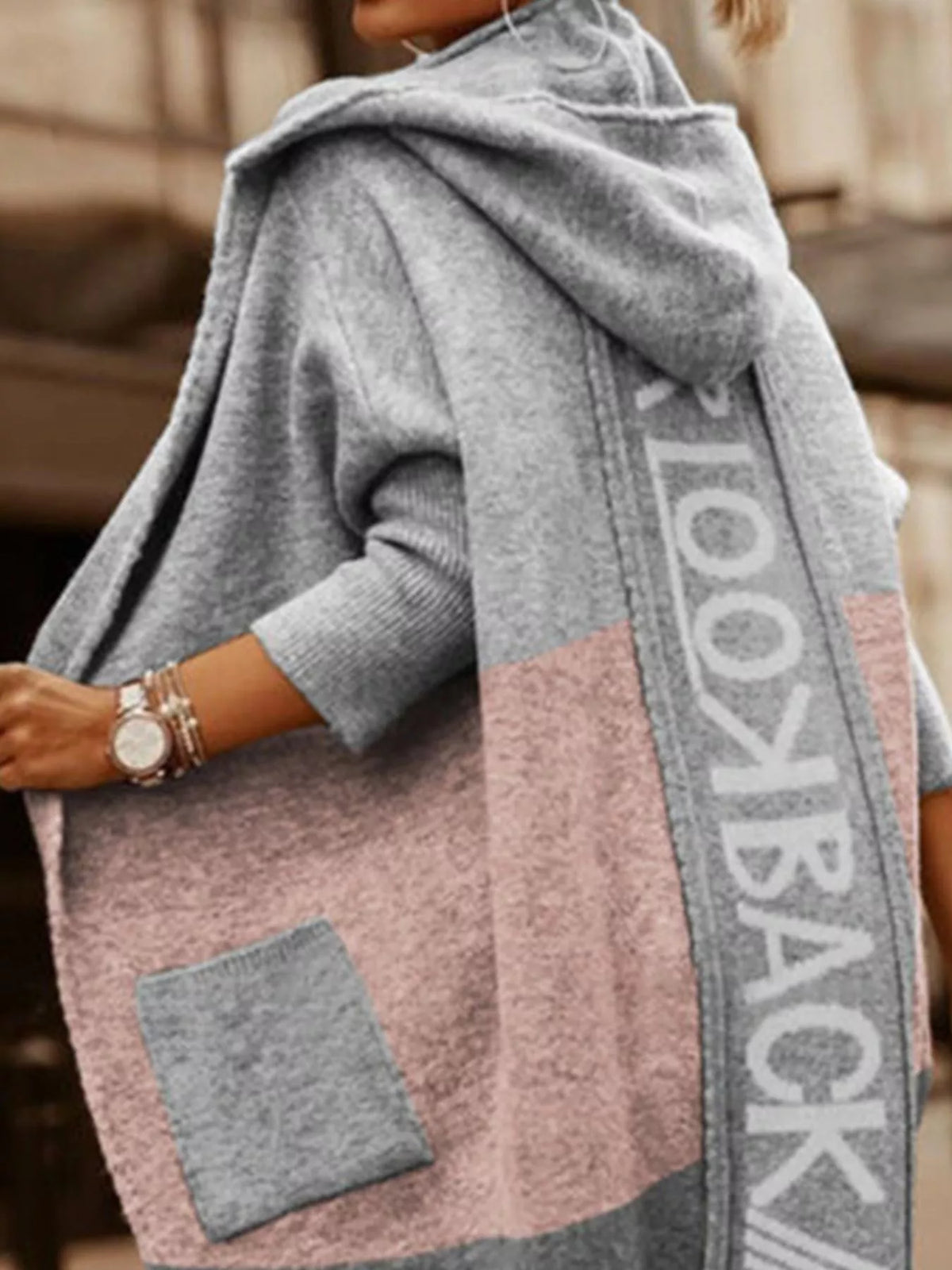 Gray and pink hooded jacket with 'LOOKBACK' branding on a blurred background