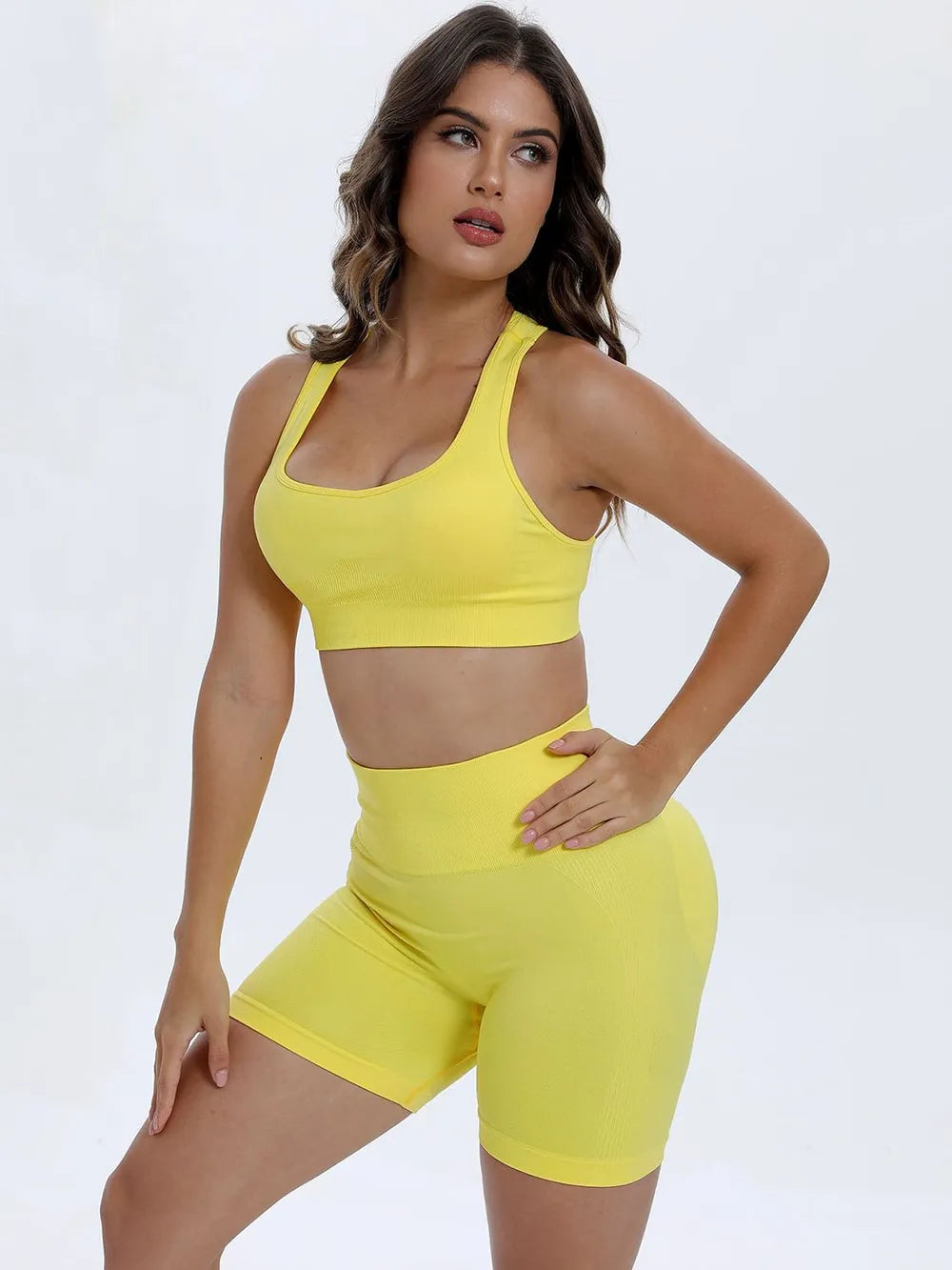 Woman wearing a yellow sports outfit on a white background