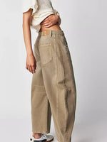Beige pants worn by a person on a white background