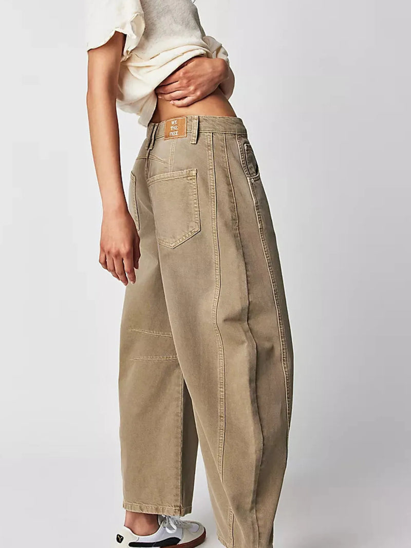 Beige pants worn by a person on a white background