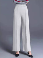 Light gray wide-leg pants worn with a striped top on a gray background