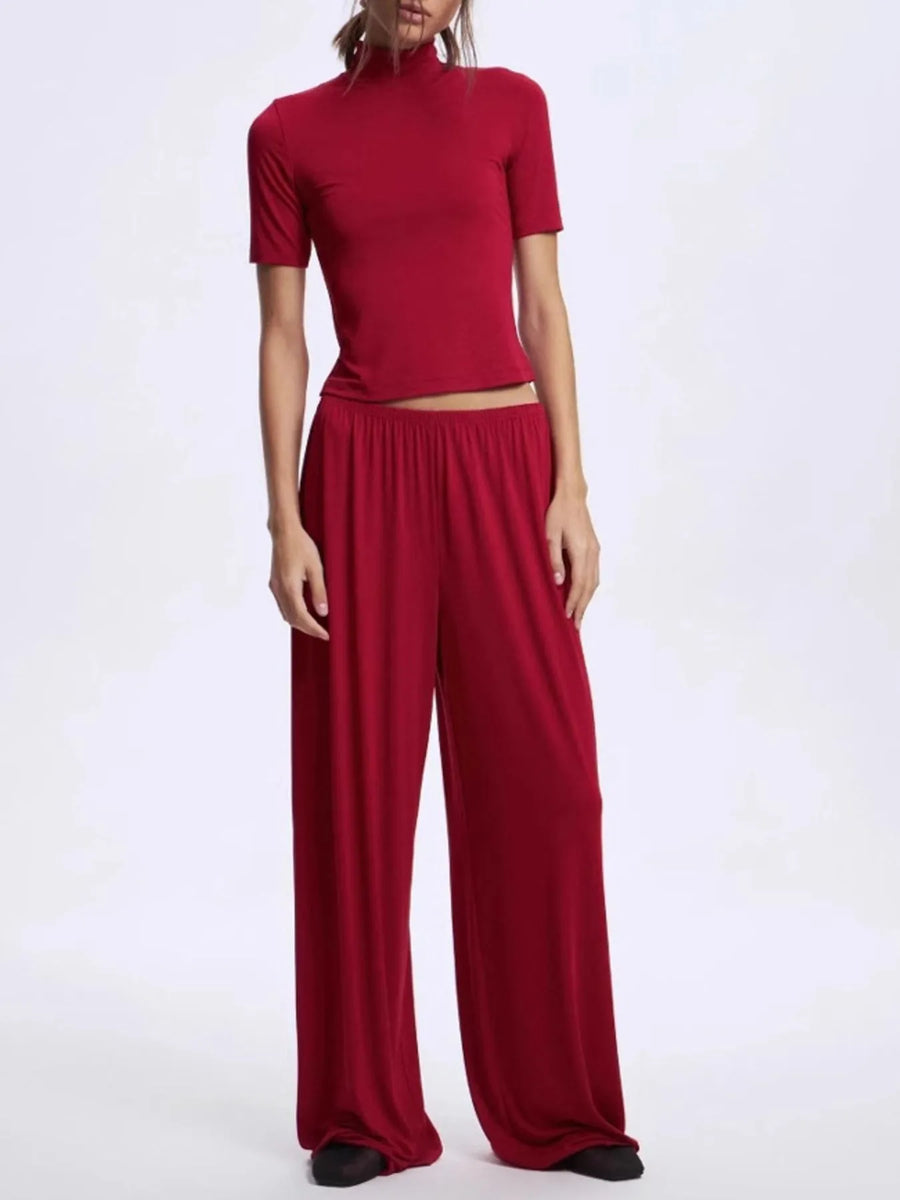 Red outfit with a top and wide-leg pants on a white background