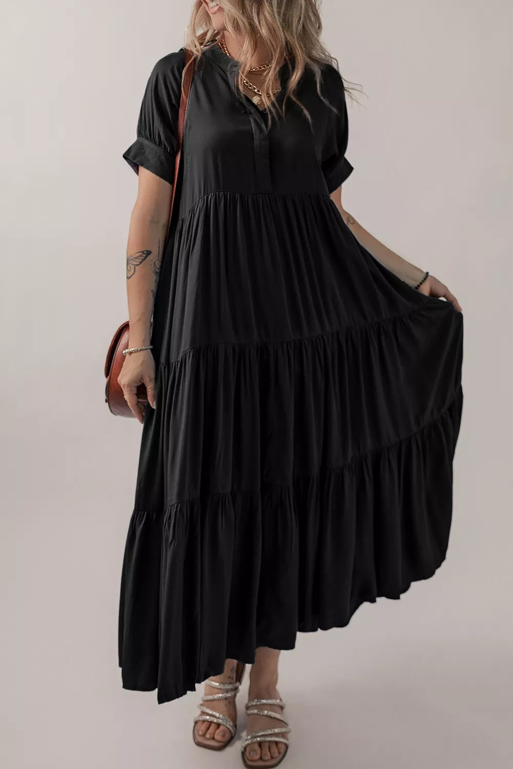 Woman wearing a black dress with a plain background