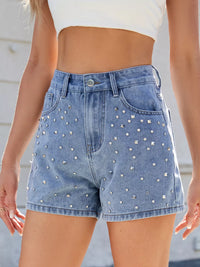 Denim shorts with rhinestone embellishments worn by a person.