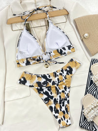 Leopard print bikini set on a hanger with a white background