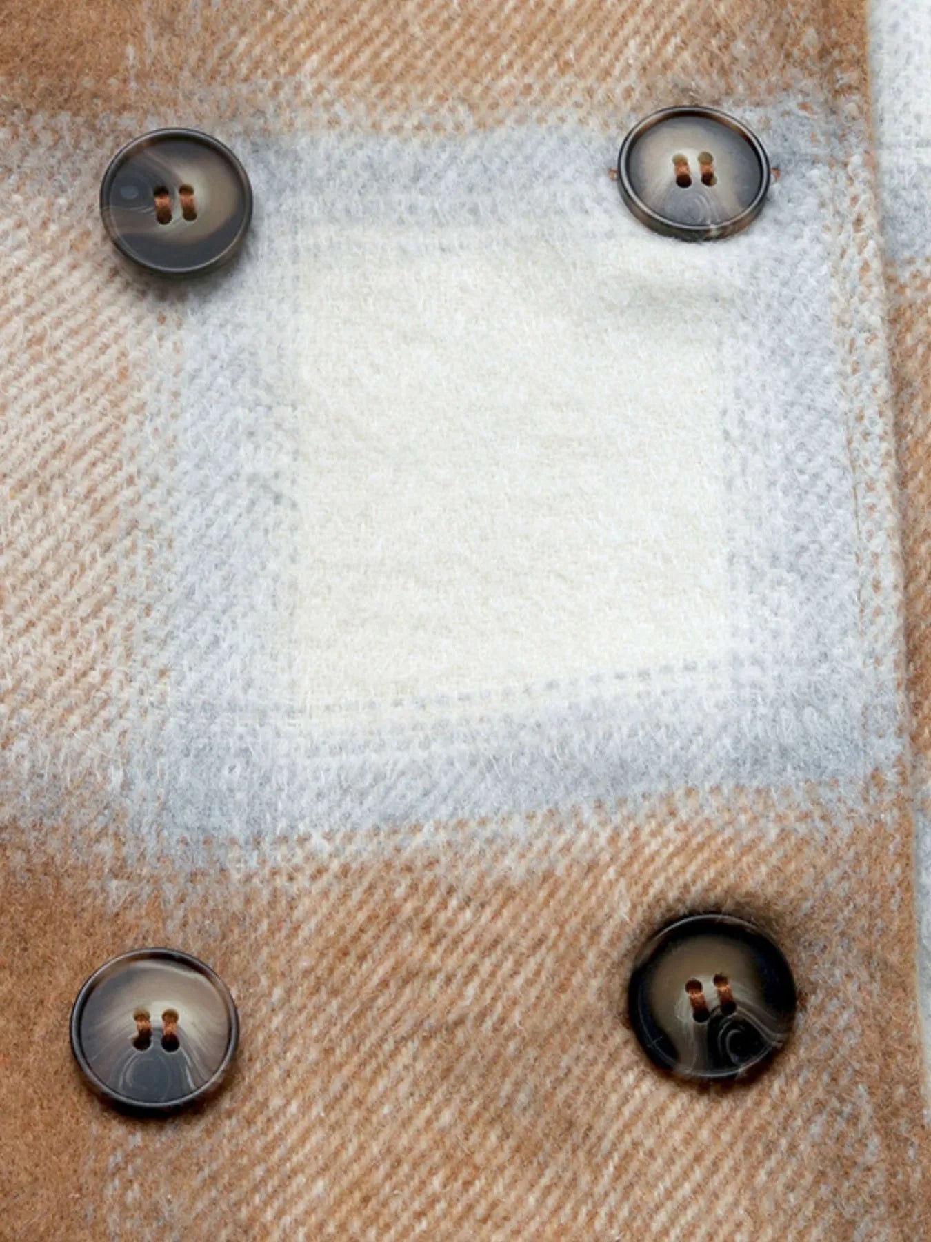 Close-up of a textured fabric surface with buttons