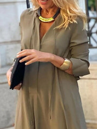 Woman wearing a green dress with a blurred background