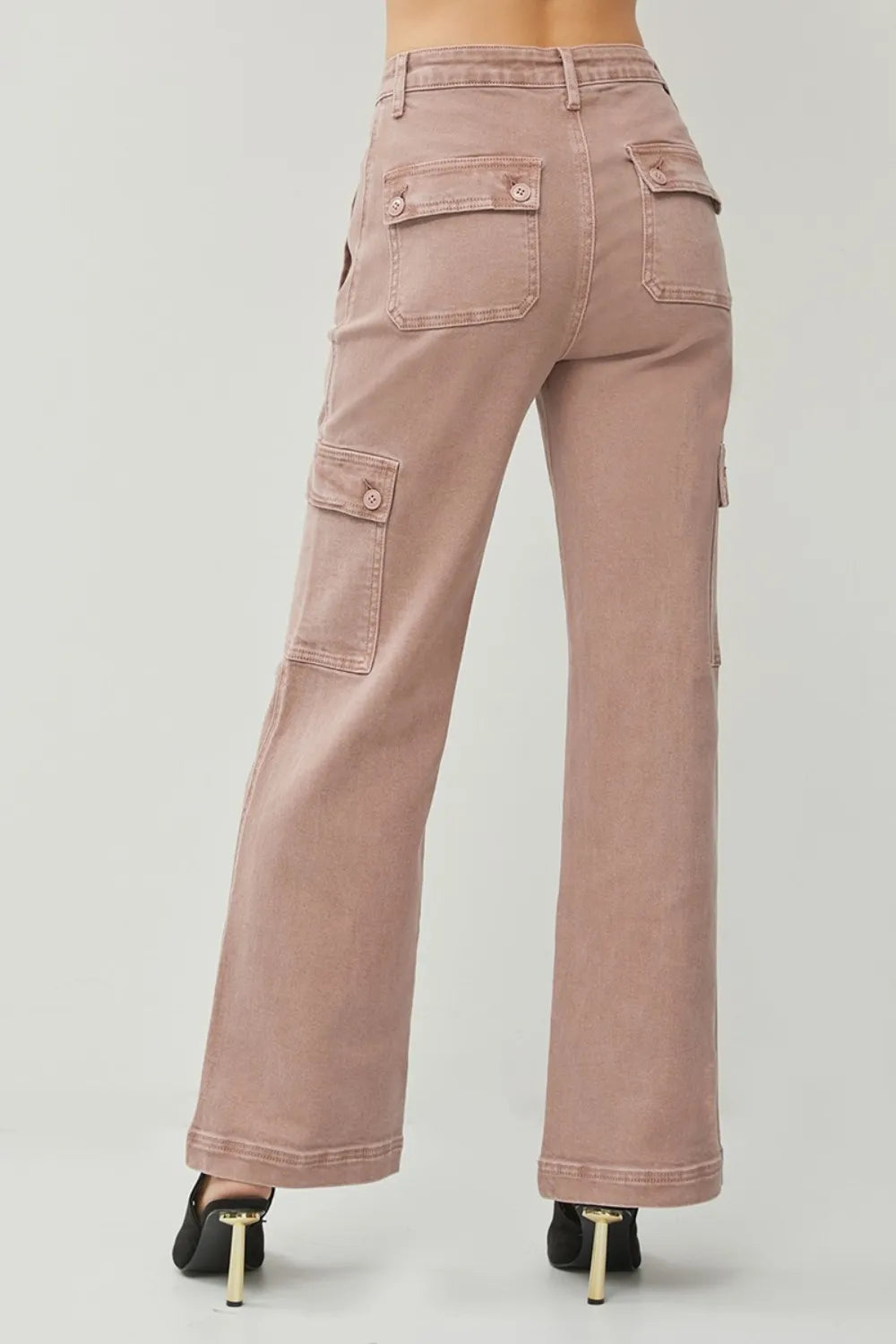 Pink cargo pants on a plain background