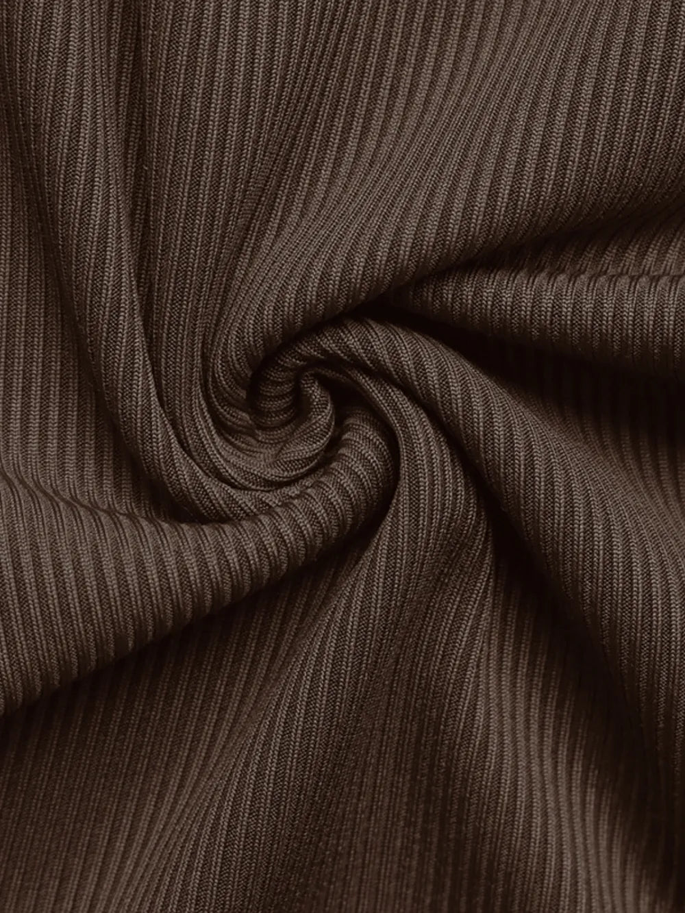 Close-up of brown ribbed fabric with a swirling pattern