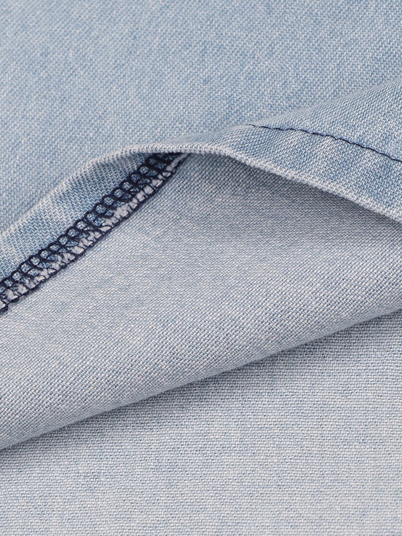 Close-up of blue denim fabric with a visible seam.
